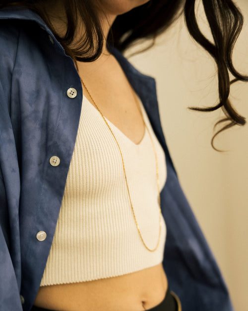 24K Gold-Plated Chain Necklace worn by model layered over cream ribbed top with blue shirt and gold chain belt