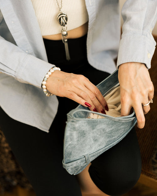 Denim Effect Baguette Bag flat lay on white bedding with silver necklace and pearl bracelet