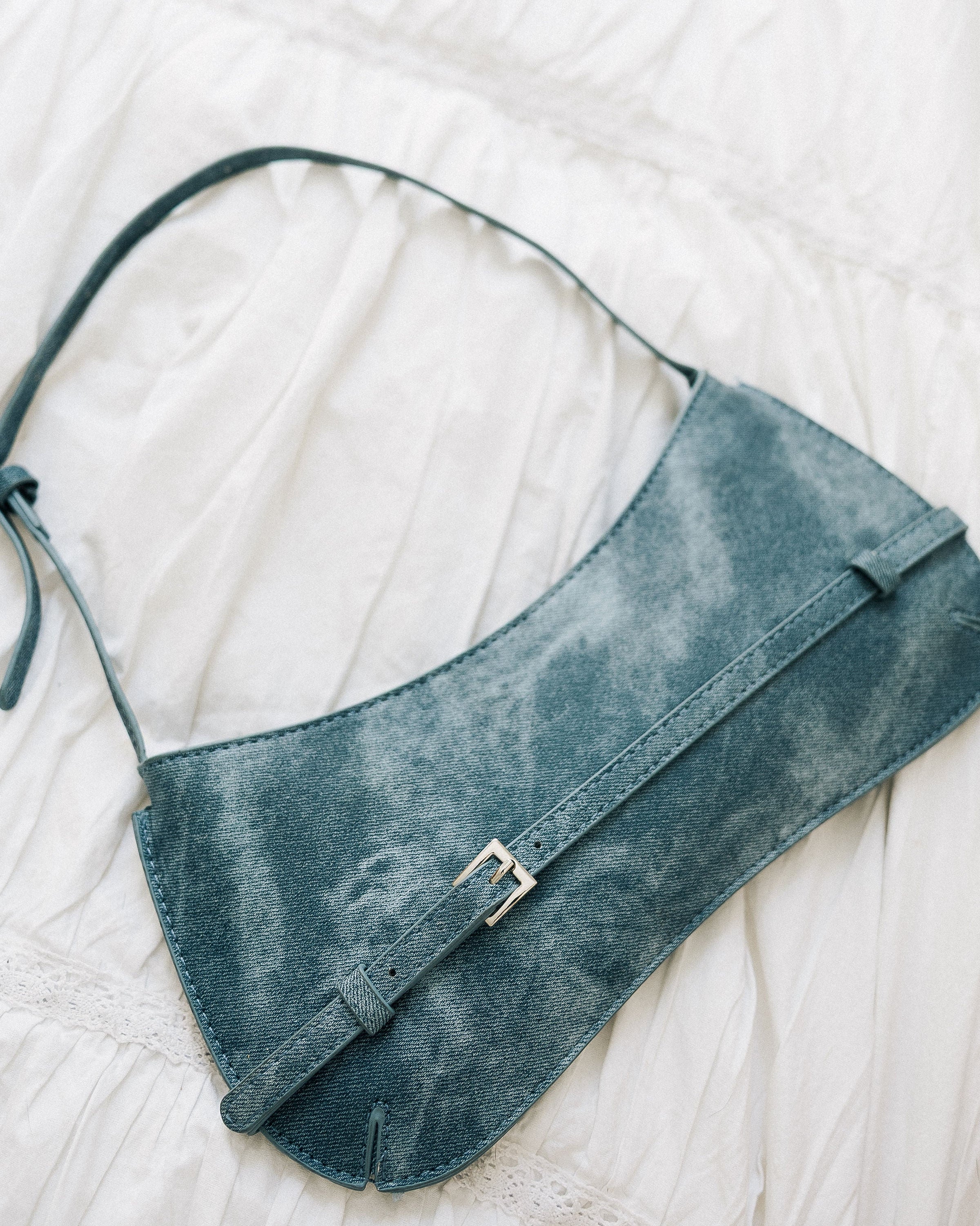 Denim Effect Baguette Bag worn on shoulder close-up showing washed texture and buckle