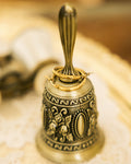 Gold-Plated Textured Hoop Earrings and gold rings on lace doily with vintage silver bell
