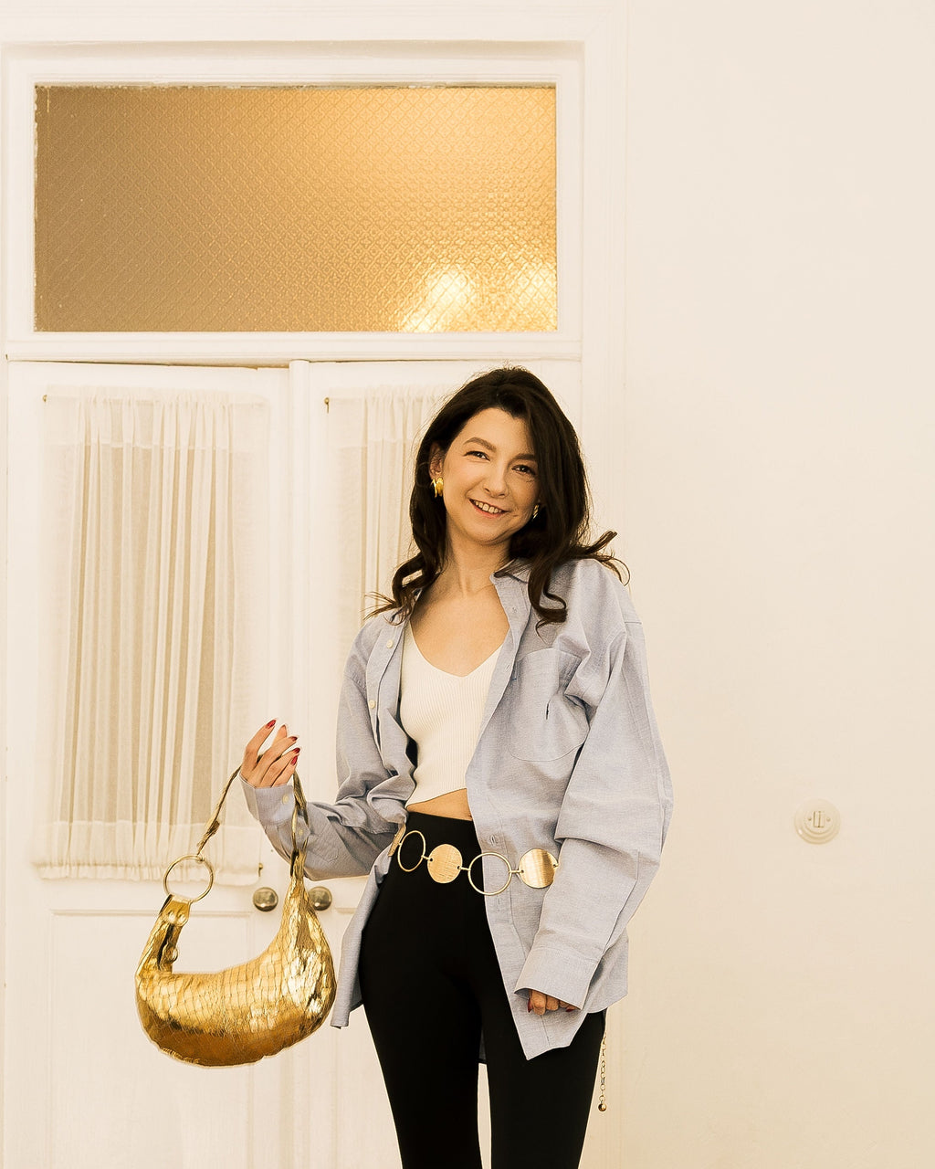 Gold Metallic Crescent Bag worn by model in grey shirt and black leggings