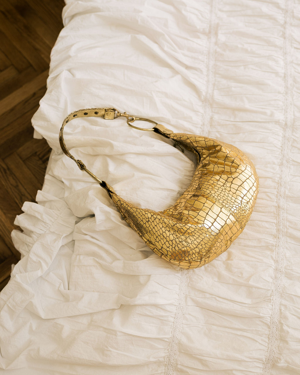 Gold Metallic Crescent Bag side view worn by model in grey shirt
