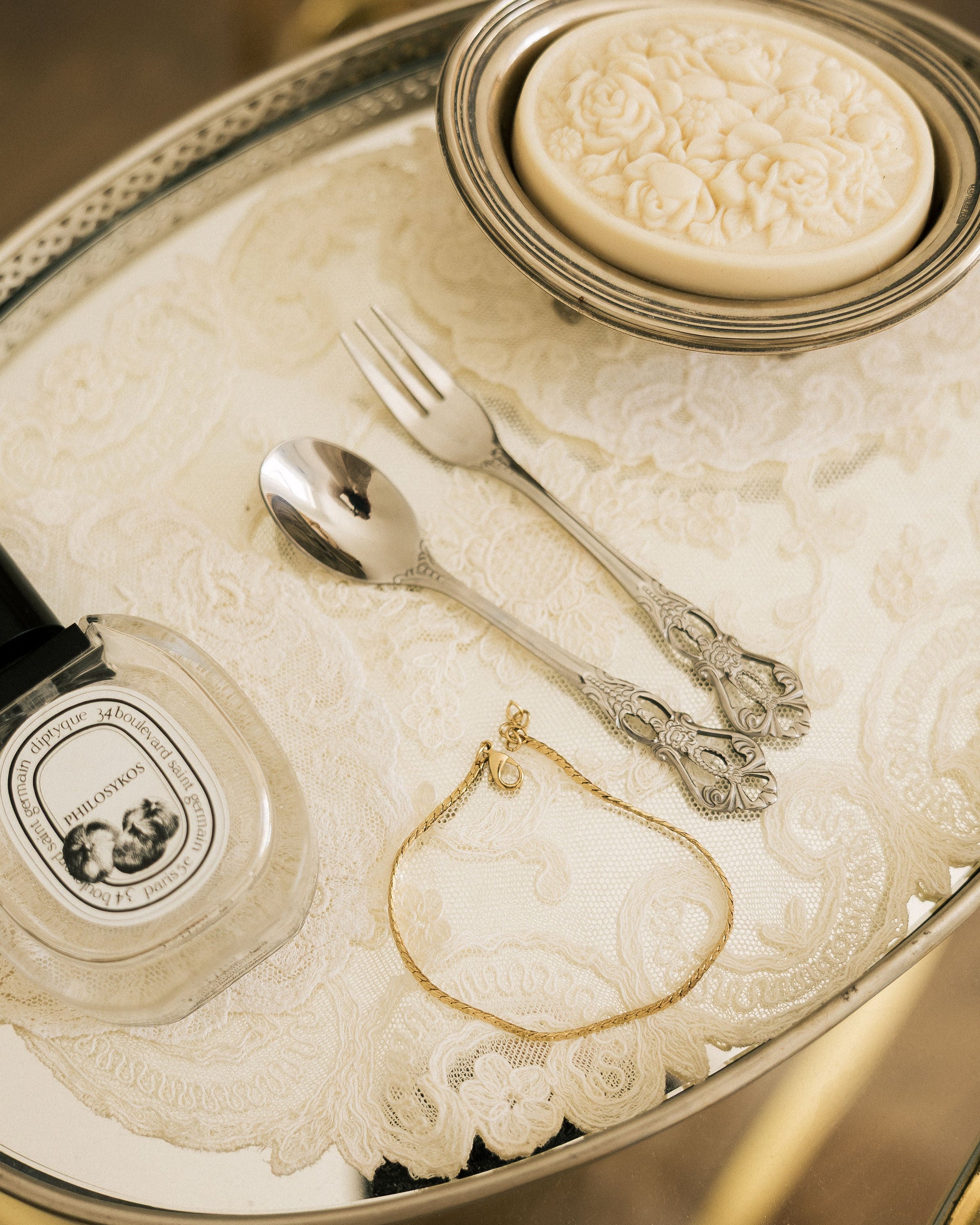 Gold Plated Chain Bracelet Anklet on silver tray with Diptyque candle and vintage cutlery