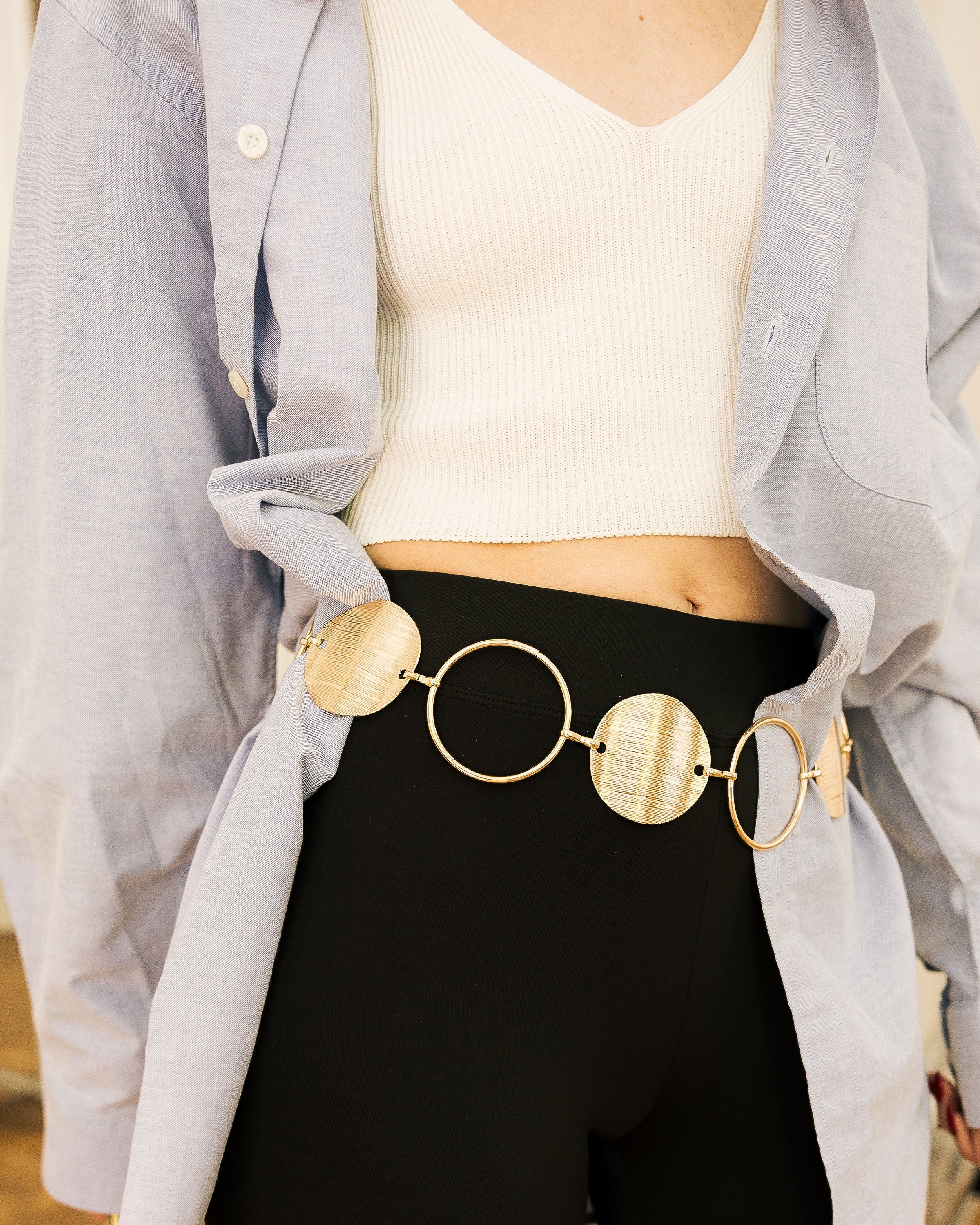 Gold Statement Disc Belt flat lay on white ruffled fabric