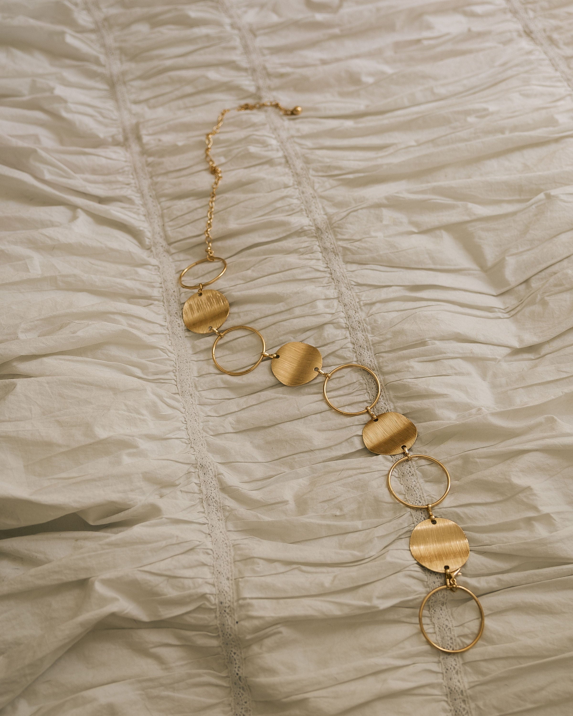 Gold Statement Disc Belt close-up showing brushed disc and ring detail