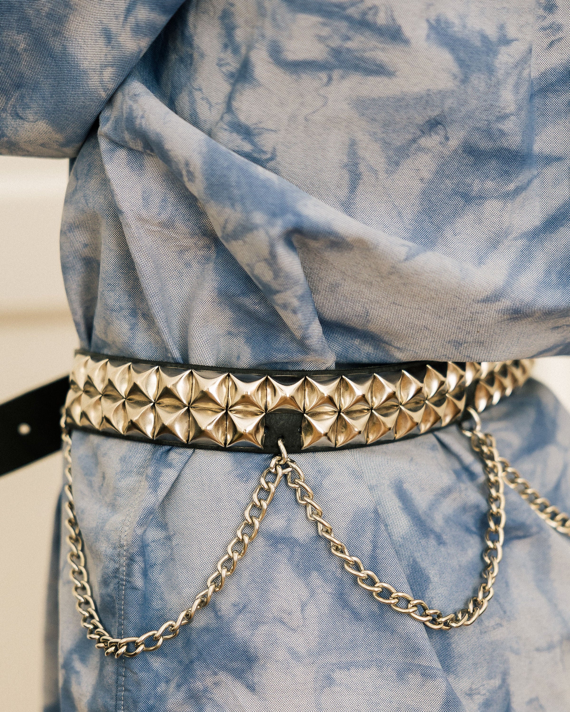 Leather Chain Statement Belt full body shot on model in tie-dye shirt and black leggings