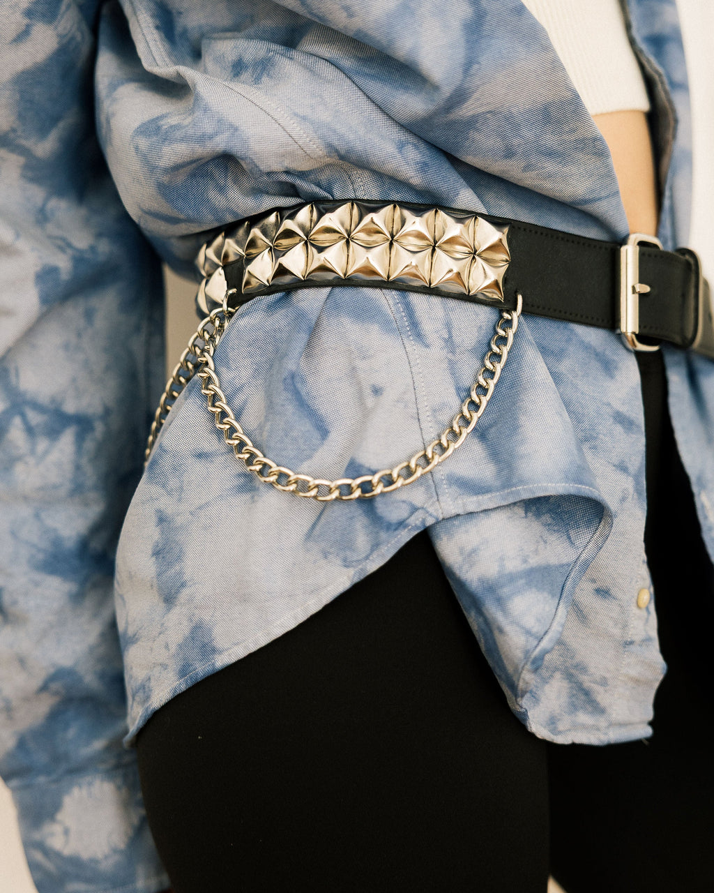 Leather Chain Statement Belt worn by model in tie-dye shirt and white crop top close-up