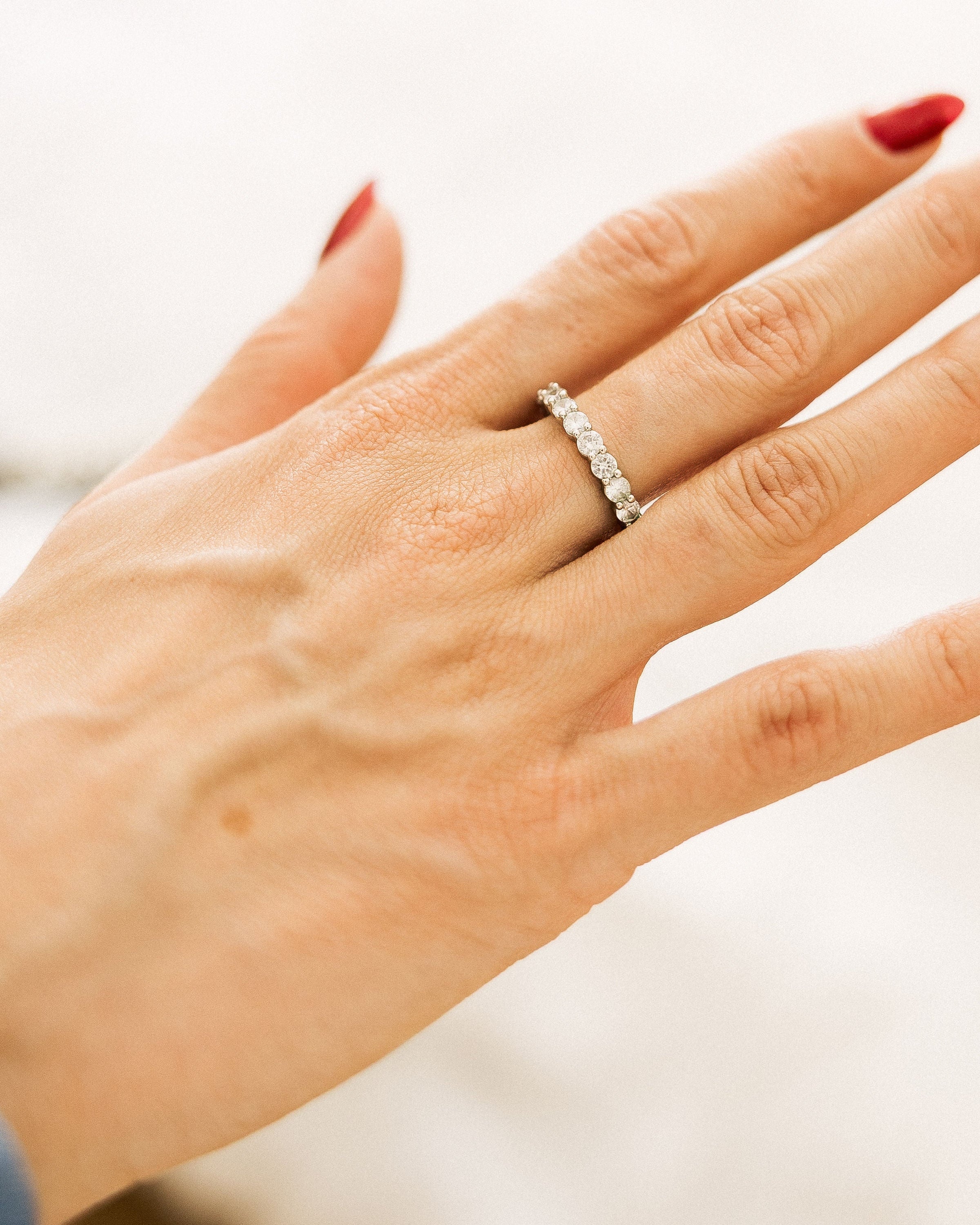 Minimal crystal band ring with sparkling clear stones worn on hand