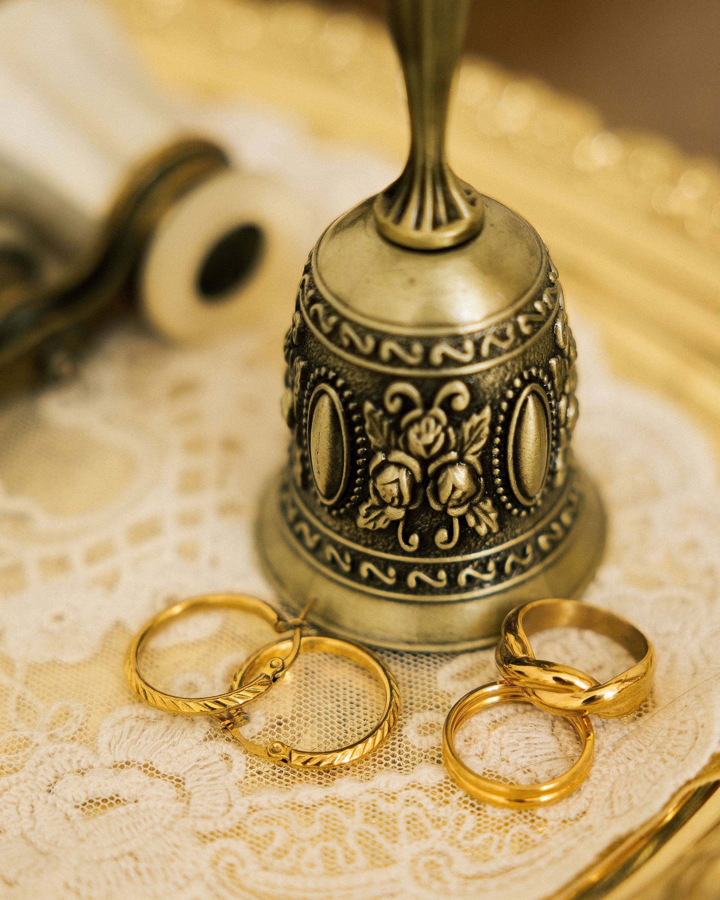 Minimalist dome ring on vintage lace with antique bell