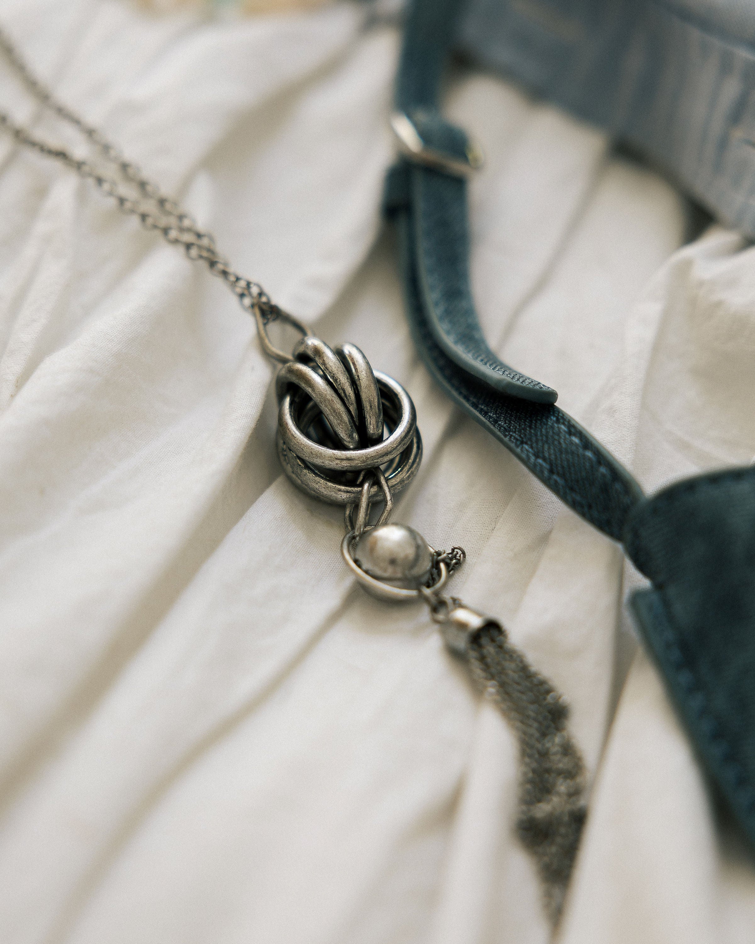 Statement Knot Tassel Necklace close-up held in hand showing knot and tassel detail