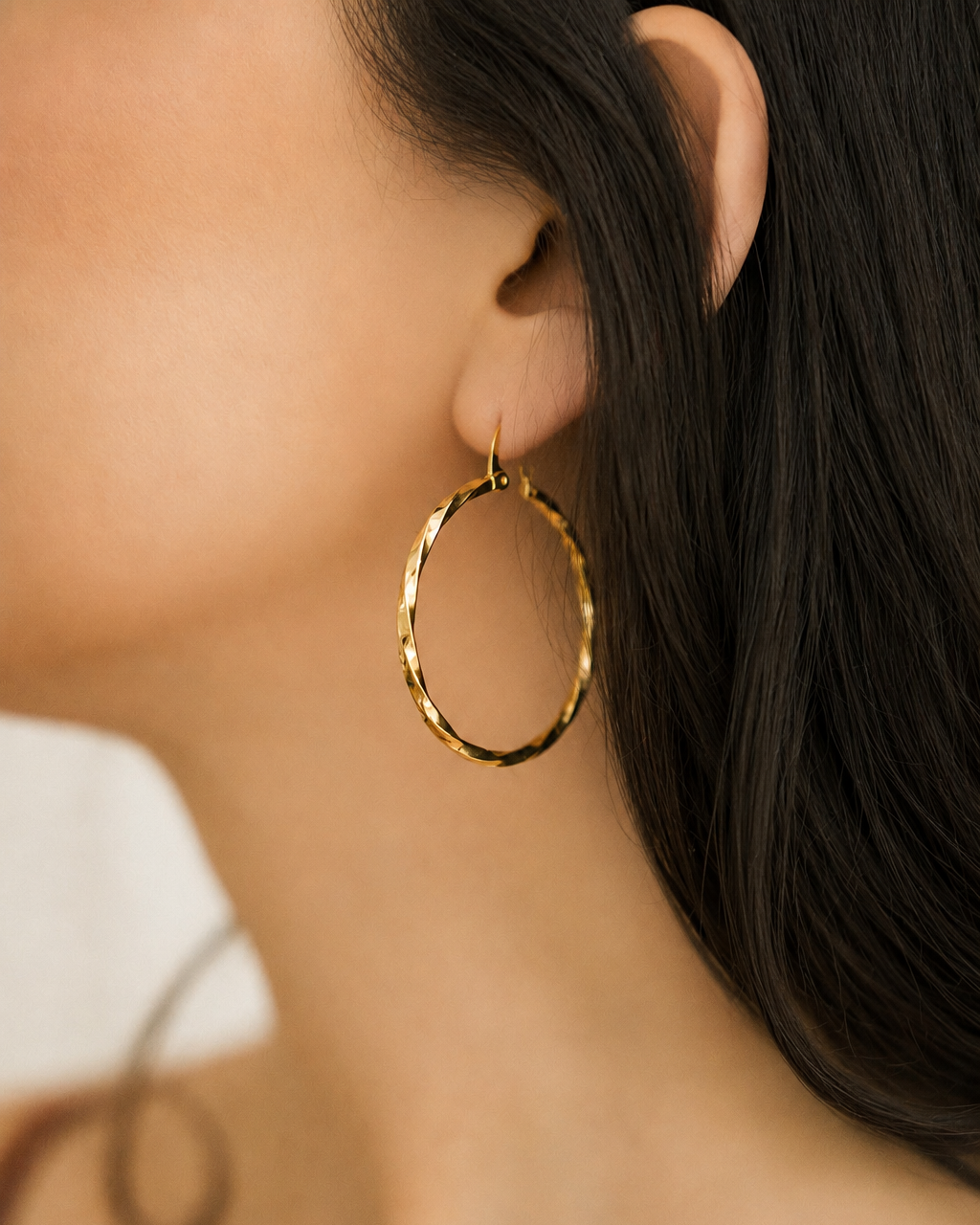 Textured Gold Hoop Earrings pair on white stone on silver vintage tray