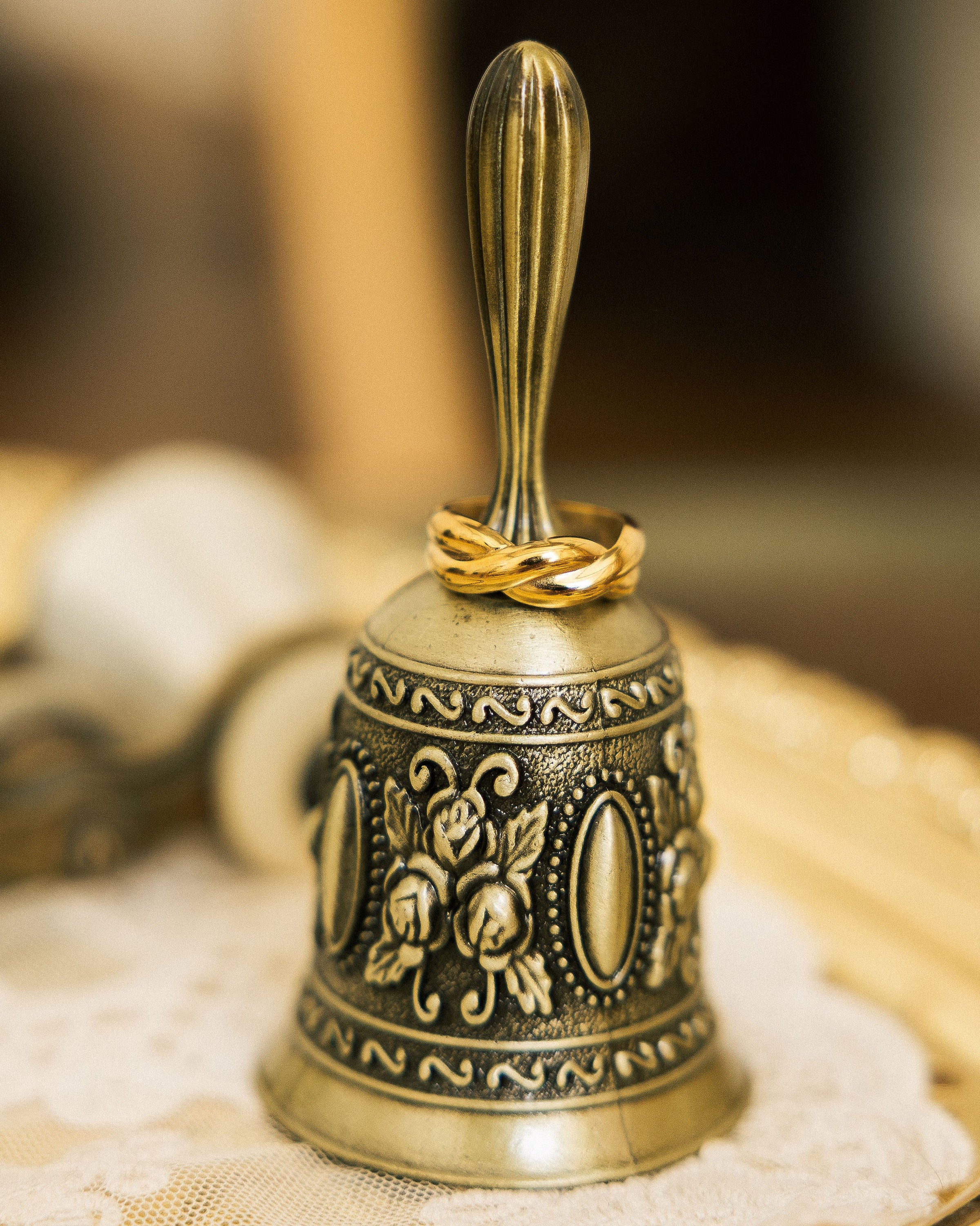 Twisted gold-plated ring on vintage bell