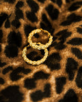Vintage Braided Clip-On Earrings pair on leopard print fabric showing braided gold texture