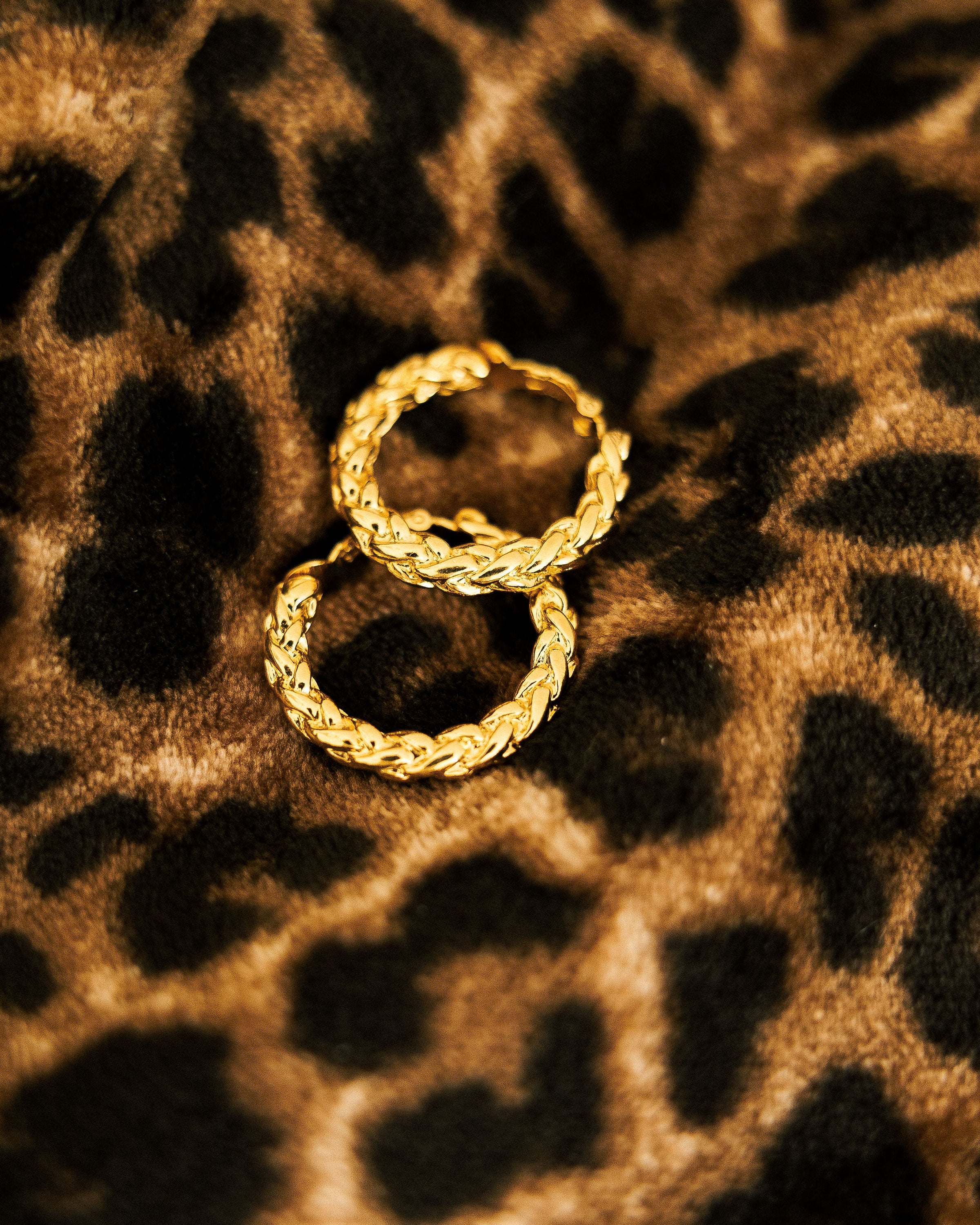 Vintage Braided Clip-On Earrings pair on leopard print fabric showing braided gold texture