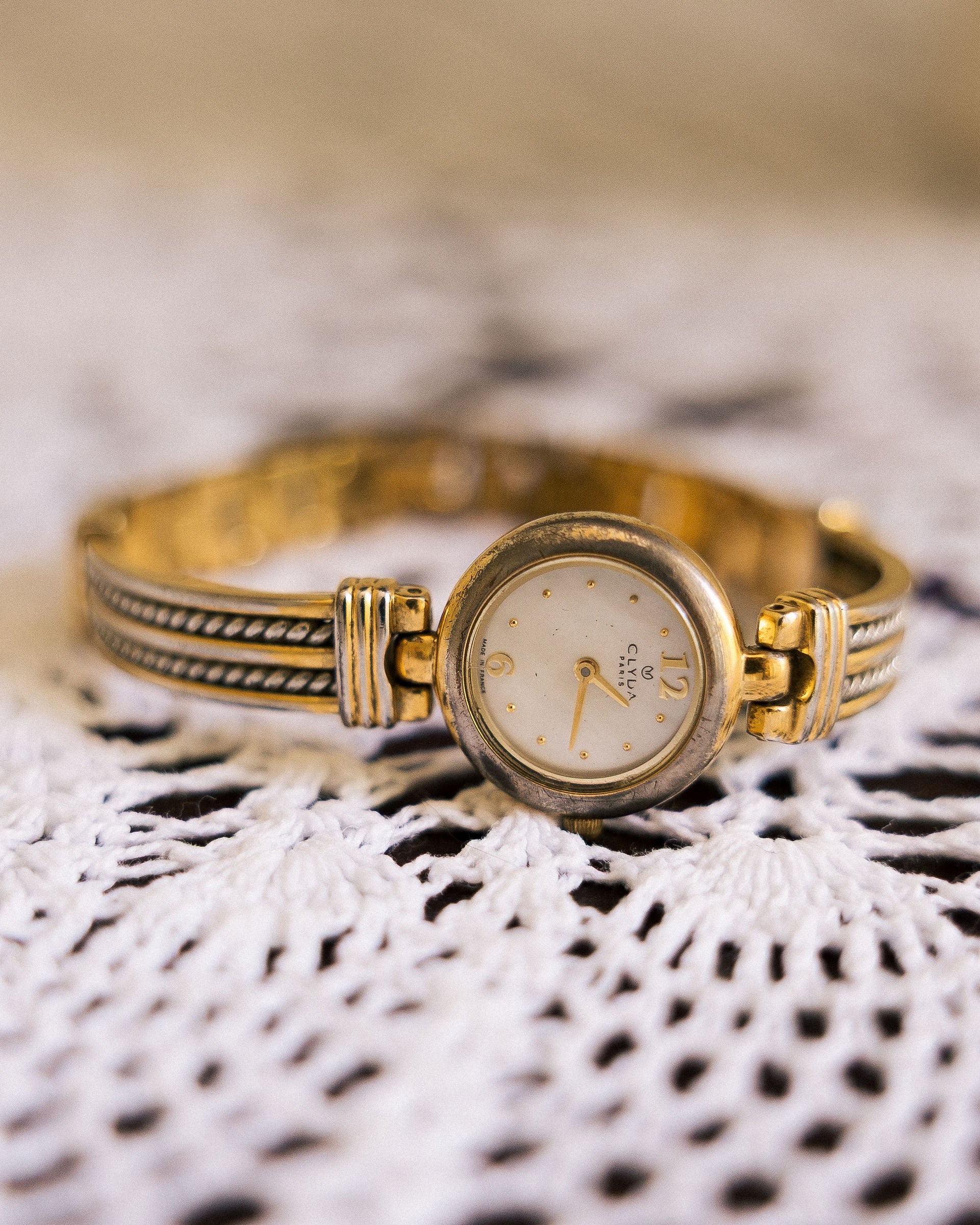 Vintage Gold-Tone Bracelet Watch close-up on lace