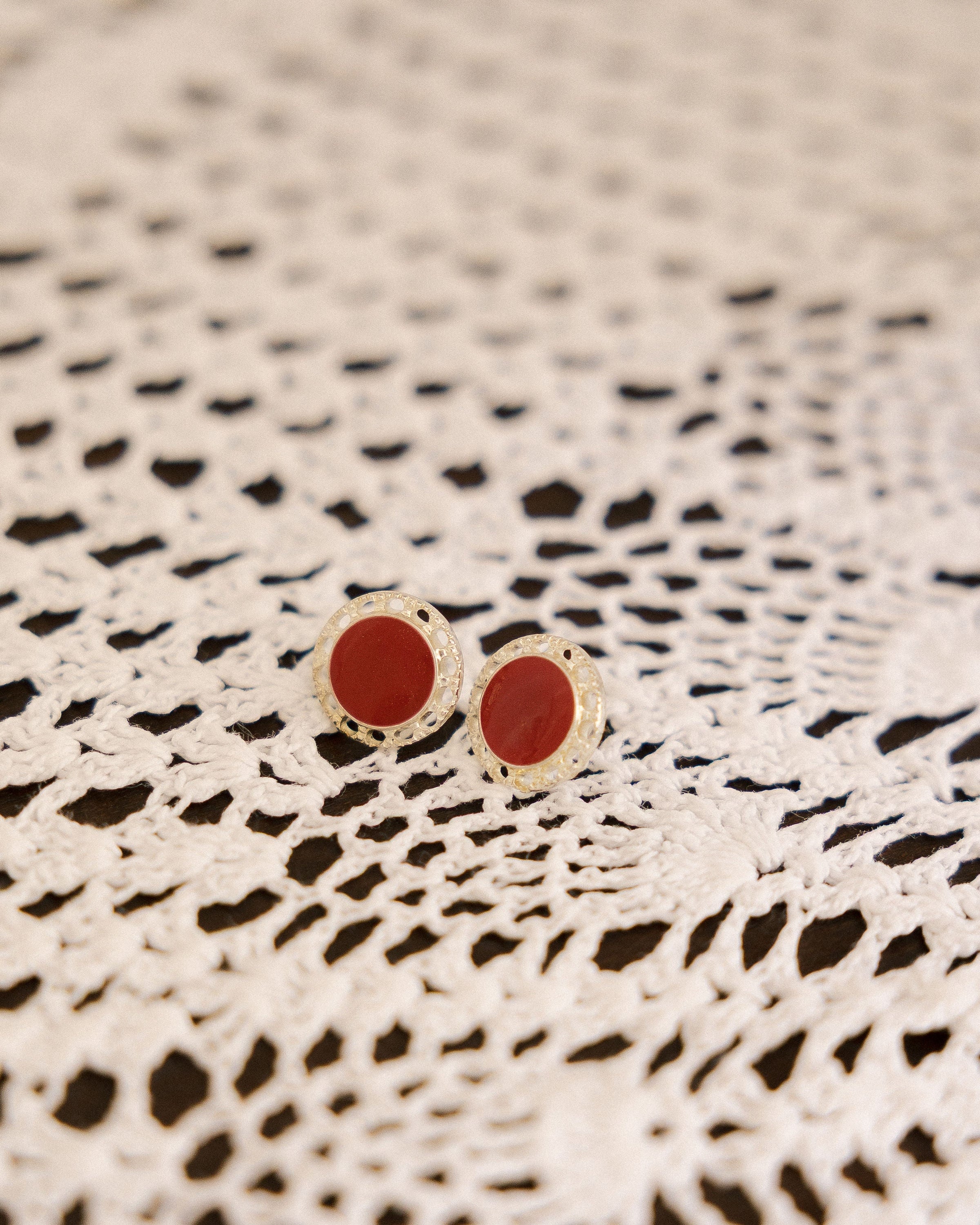 Vintage Red & Silver Stud Earrings pair on black and white crochet lace cloth