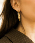 Vintage Textured Hoop Earrings and gold ring on white stone on silver vintage tray