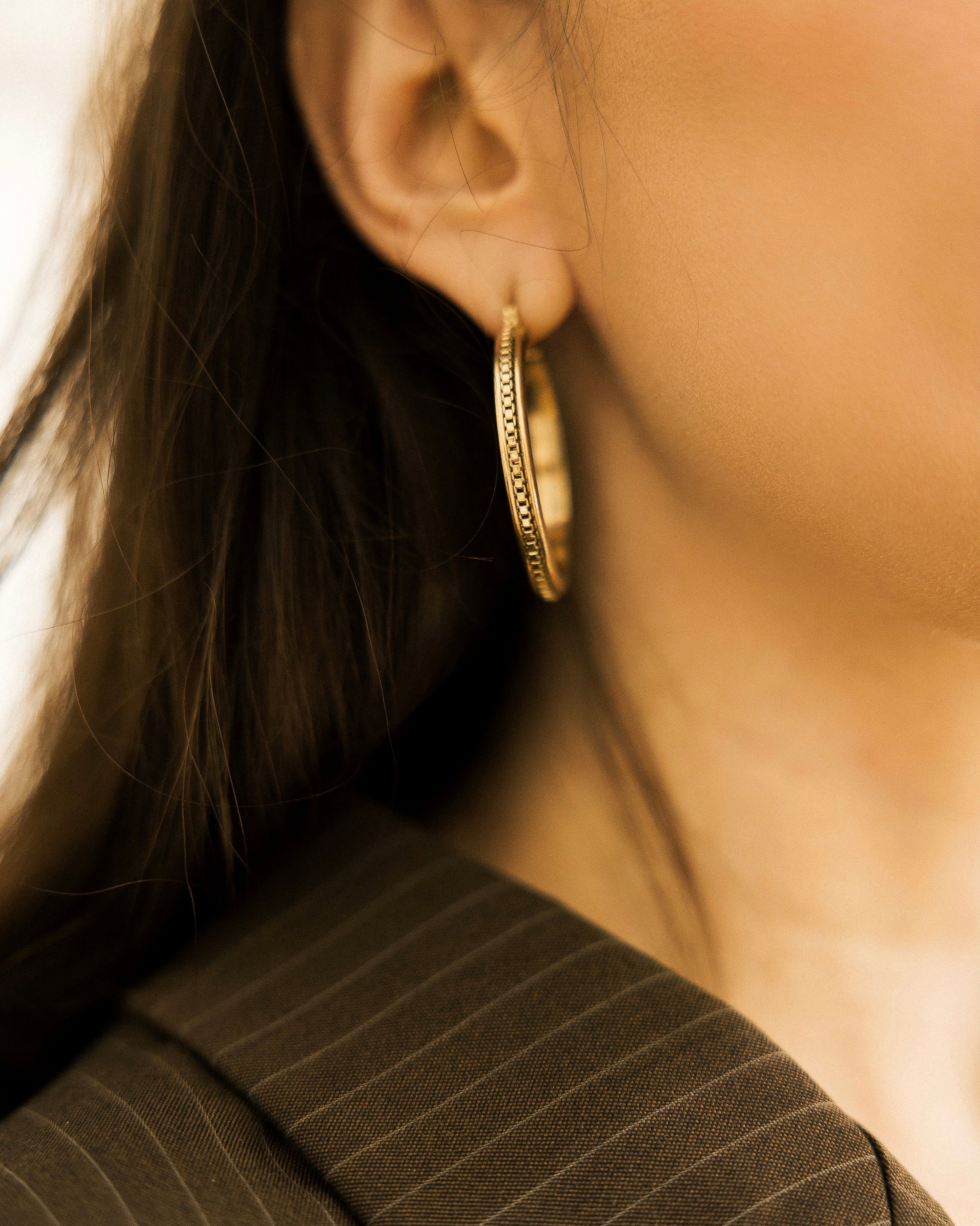 Vintage Textured Hoop Earrings and gold ring on white stone on silver vintage tray