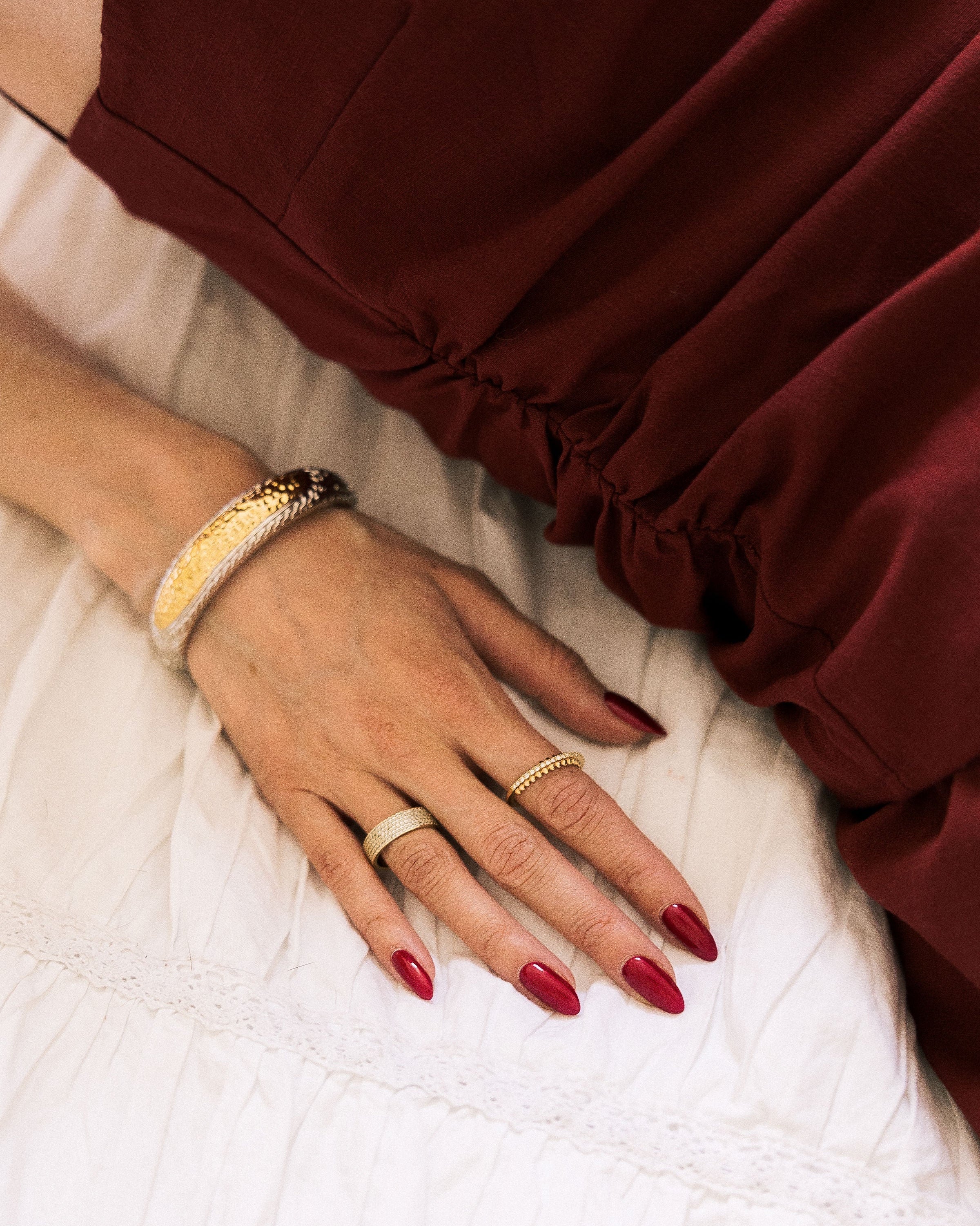 Vintage Two-Tone Textured Bangle worn on wrist with rings in burgundy outfit